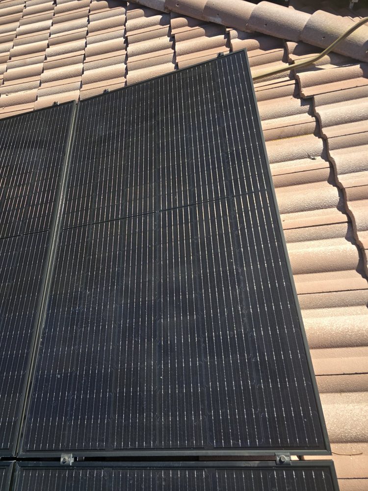Close-up of a freshly cleaned solar panel, the glass dark and clear
