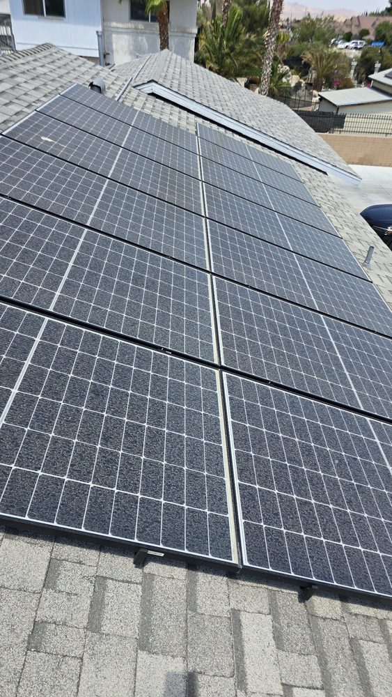 Dusty solar panels on a shingle roof, before cleaning