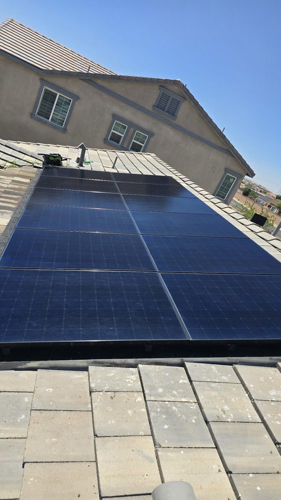 The same grey tile roof array after cleaning, deep blue and clean
